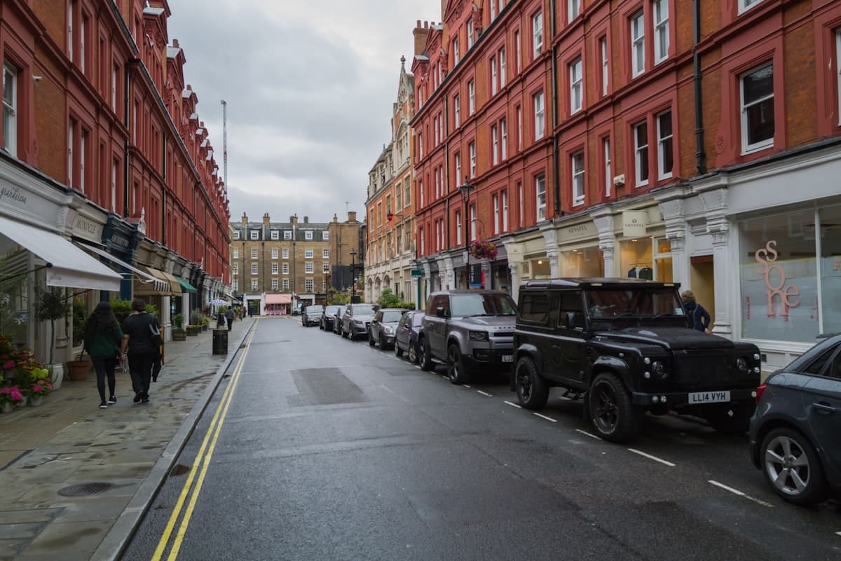 Residential street with parked cars outside an estate